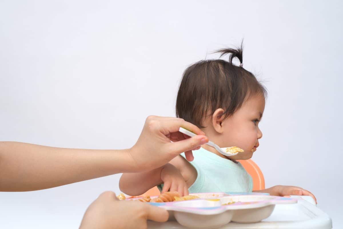 Nutrition healthy eating habits for kids concept. baby do not like to eat food. Little cute kid girl refuse unhappy and unlike to eat healthy food.